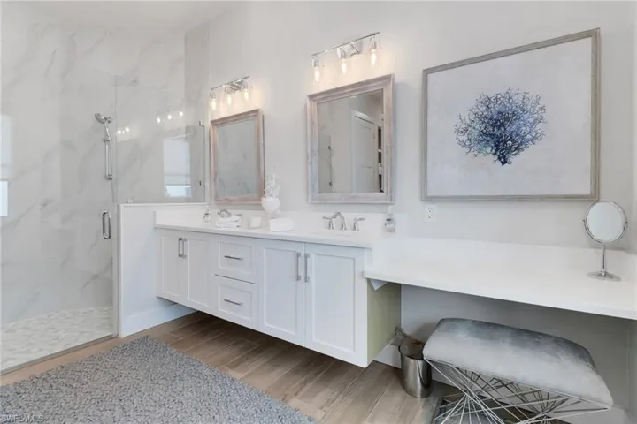 Bathroom featuring vanity, a shower with shower door, and hardwood / wood-style floors