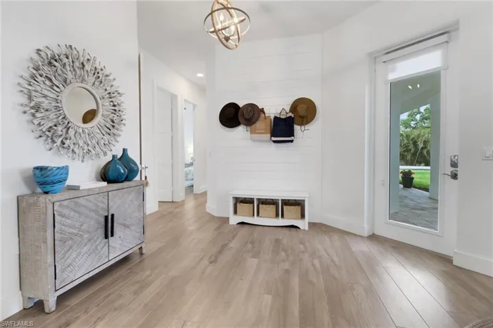 Entryway featuring an inviting chandelier and light wood-type flooring