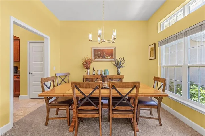Dining space with carpet floors and a chandelier