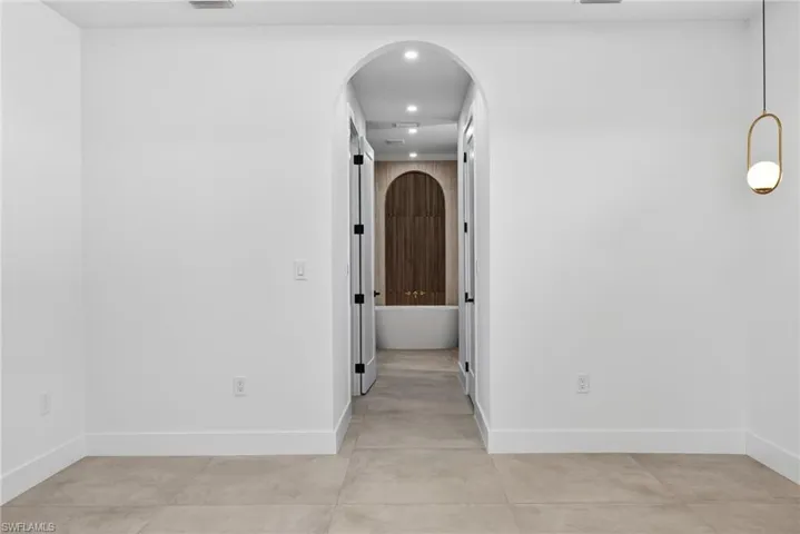Hall with arched walkways and recessed lighting