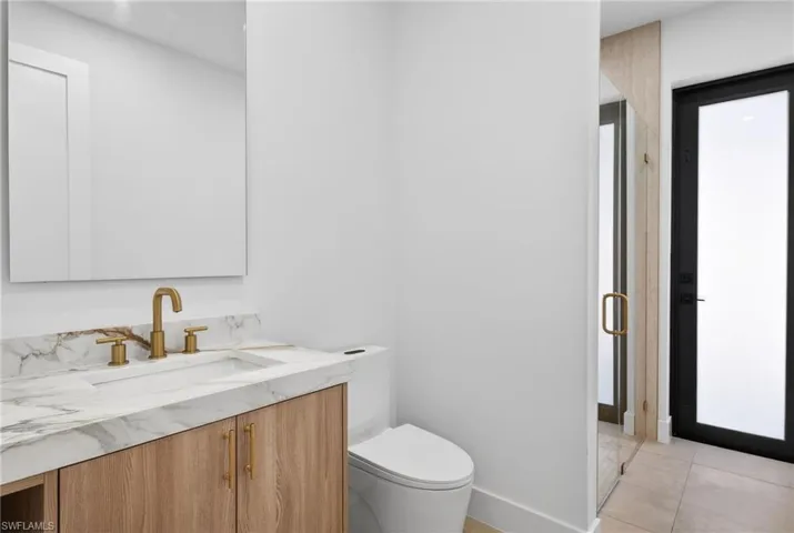 Bathroom with vanity, a stall shower, and light tile patterned floors