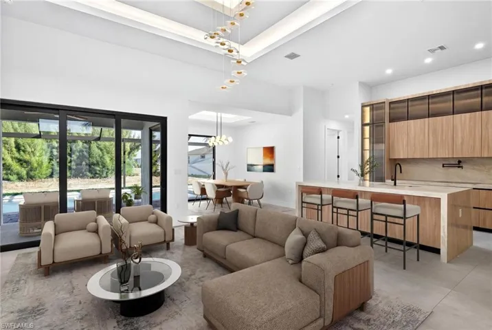 Living area with hanging lights and a high ceiling
