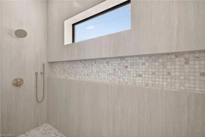 Full bathroom featuring tiled shower