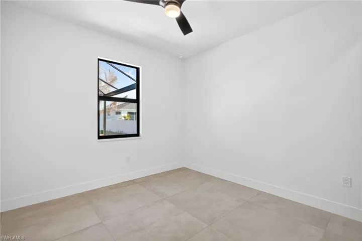 Spare room with baseboards and ceiling fan