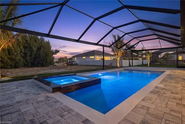 Integrated pool / hot tub featuring a lanai, a patio area, and a sunroom