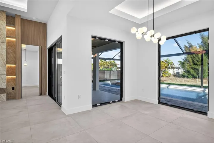 Unfurnished dining area with baseboards and a chandelier