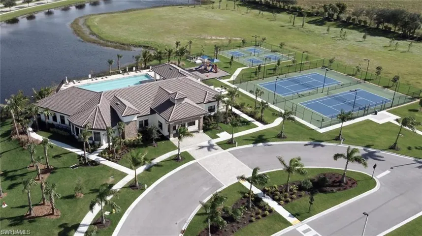 Community clubhouse featuring a swimming pool, multiple tennis courts, pickleball courts, and a playground