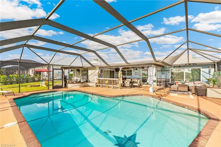 Swimming pool featuring a sunroom, glass enclosure, a patio area, and outdoor lounge area