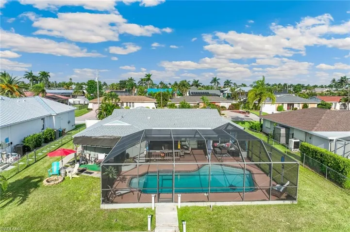 View of swimming pool with a lanai, a residential view, a fenced backyard, and a patio area