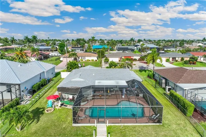 Aerial perspective of suburban area with a pool area