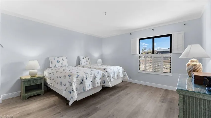 Bedroom featuring light wood-style floors and baseboards