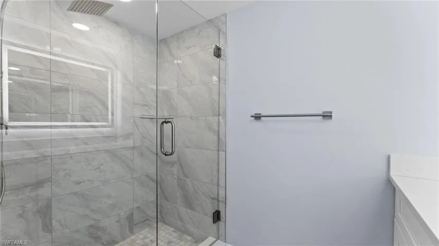 Bathroom with vanity and a shower stall
