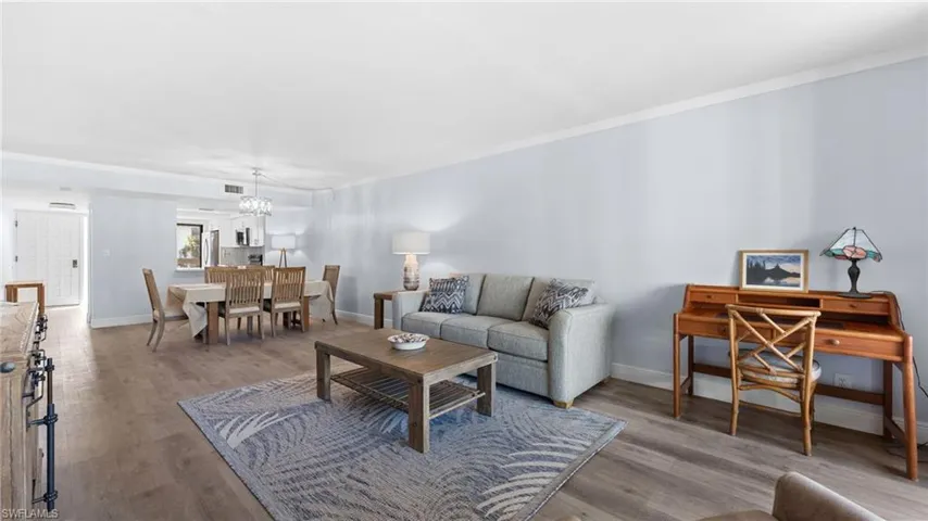 Living room with wood finished floors and a chandelier