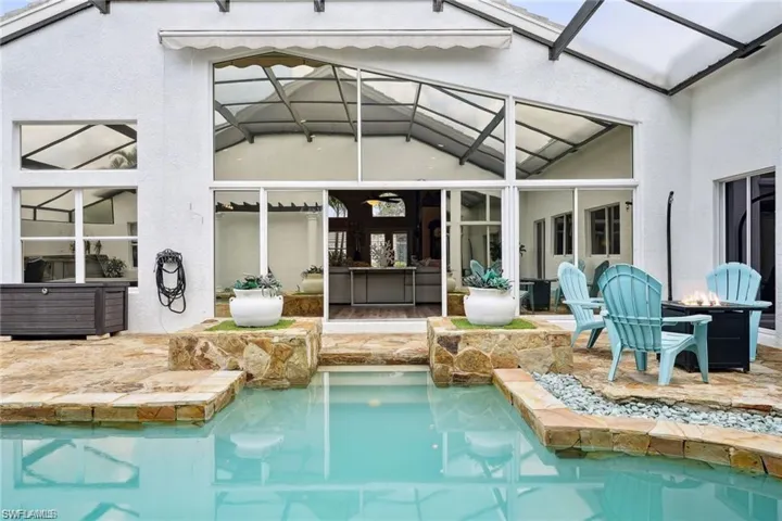 View of swimming pool with a lanai and a patio