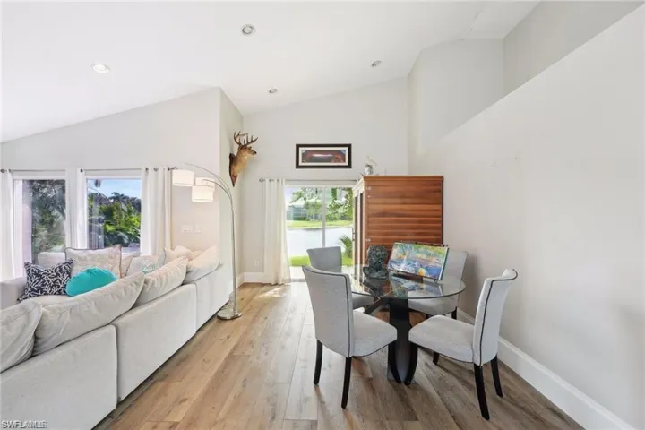 Dining area featuring lofted ceiling and light hardwood / wood-style floors