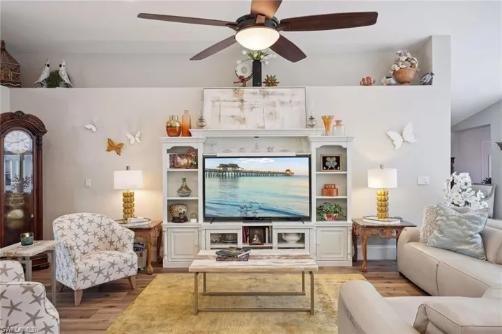 Living room featuring ceiling fan and wood-type flooring
