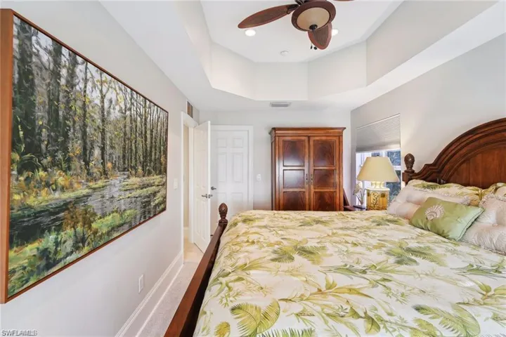 Bedroom with vinyl prank flooring and ceiling fan