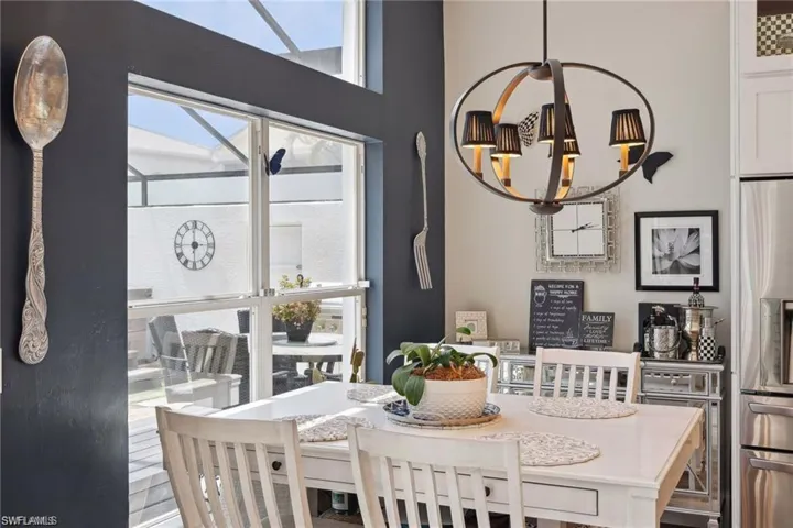 Dining room featuring a notable chandelier and vinyl prank flooring