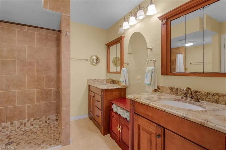 Another view of the master bathroom w/emphasis of the dual sinks and extra cabinet storage.