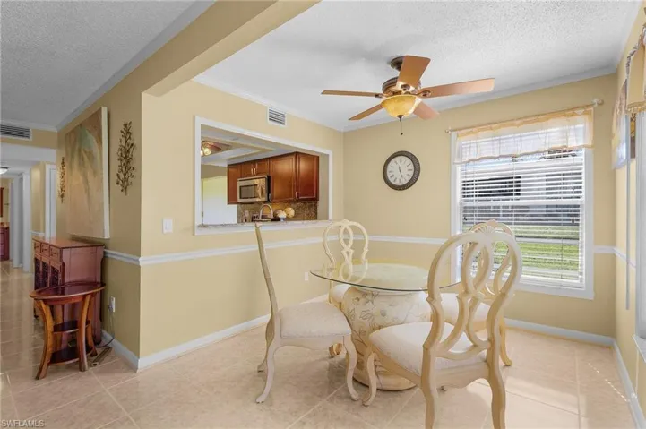 The wide pass through window makes the kitchen and dining area are cohesive to serving and socializing with guests.