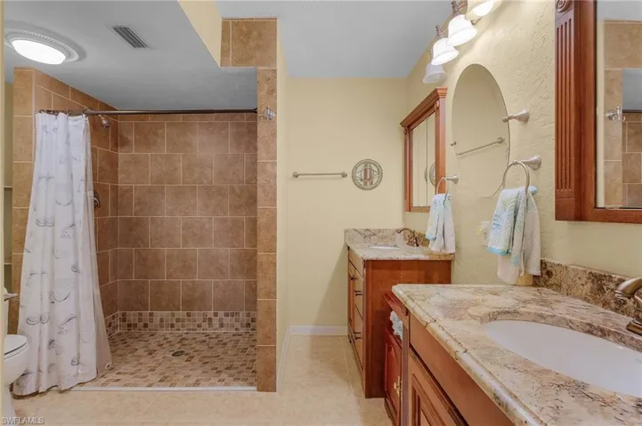 Master bathroom ensuite has a zero barrier entrance and enough room for a wheelchair if needed. Notice the dual sinks.