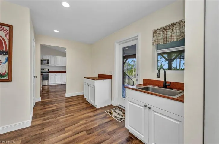 Huge Laundry/Mud room with sink, Door leads to an expansive deck ideal for gatherings and outdoor living