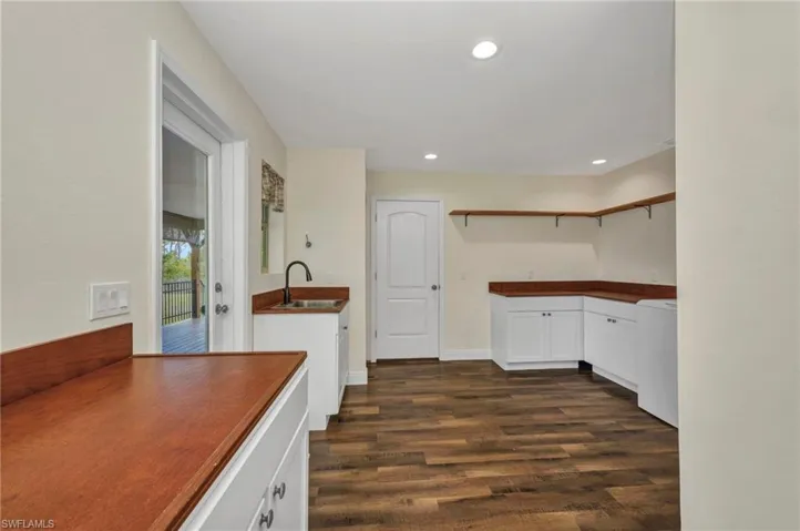 Extra-large laundry/mud room with sink, plenty of storage and shelving