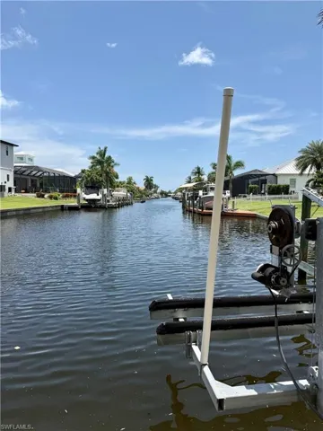 Waterfront property with direct canal access featuring a private boat lift