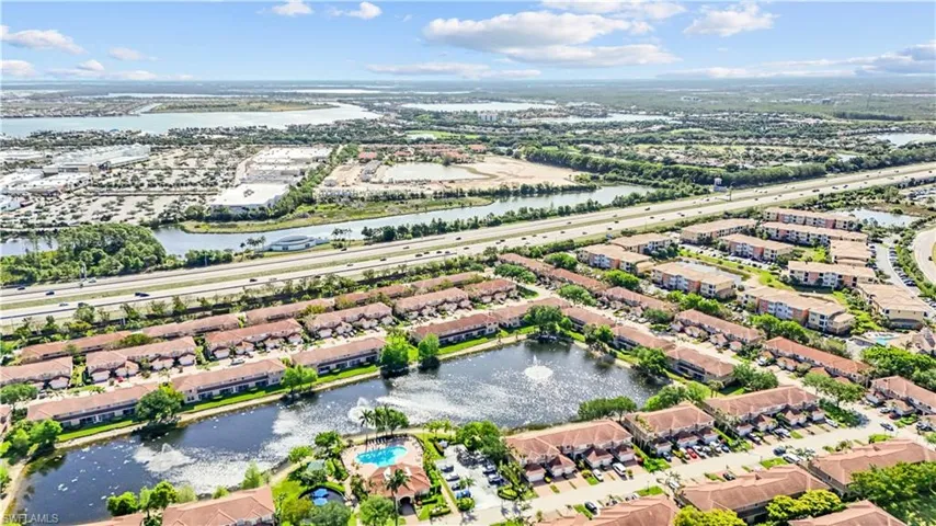 Aerial view showcasing the property's location within a community featuring water bodies and surrounding developments