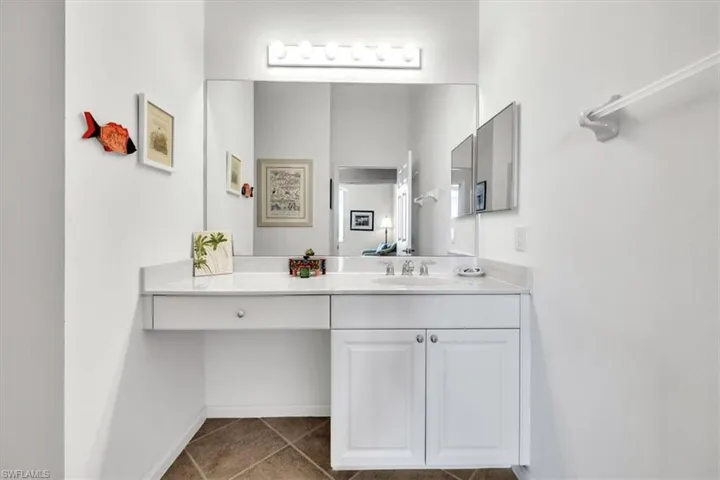 Bathroom with vanity and dark tile patterned floors