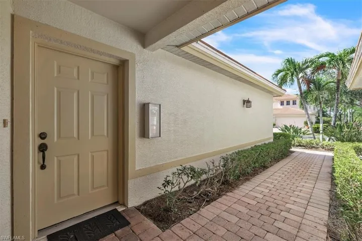 Doorway to property featuring stucco siding