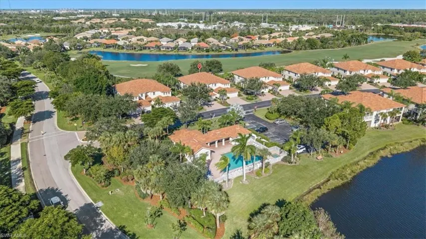 View of property location featuring a large body of water, a golf club, and nearby suburban area
