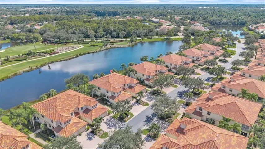 Aerial perspective of suburban area with a nearby body of water