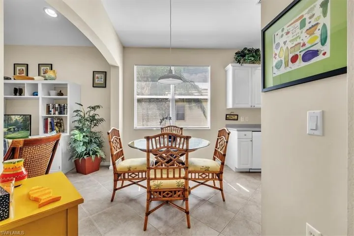 Dining area with light tile patterned floors, recessed lighting, and arched walkways