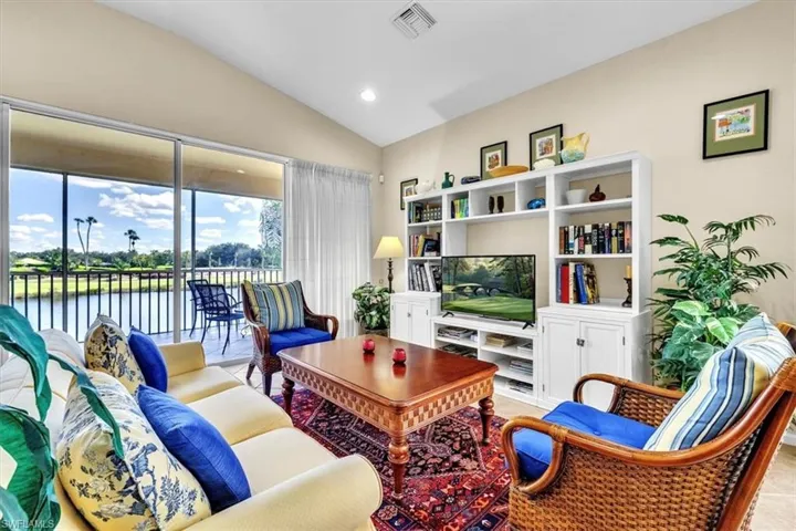 Living area with vaulted ceiling and recessed lighting