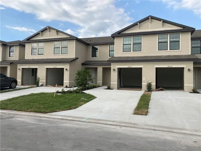 Townhome / multi-family property featuring a garage, driveway, roof with shingles, and stucco siding