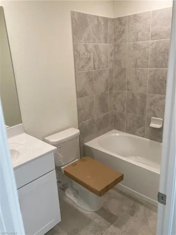 Bathroom with vanity, toilet, and tub / shower combination