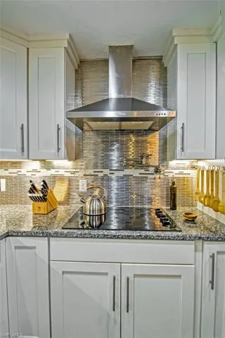 Gorgeous backsplash, stainless steel hood, and pot filler.