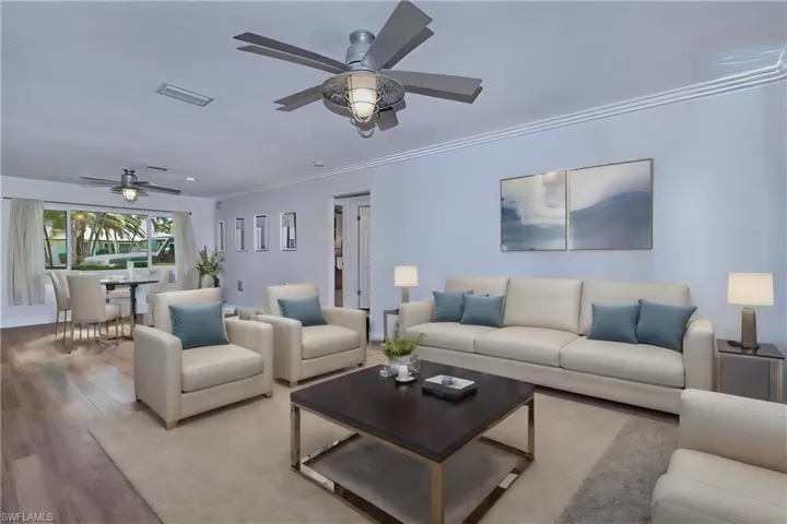Virtual staging ideas Living room with ceiling fan, light wood-style flooring, and crown molding