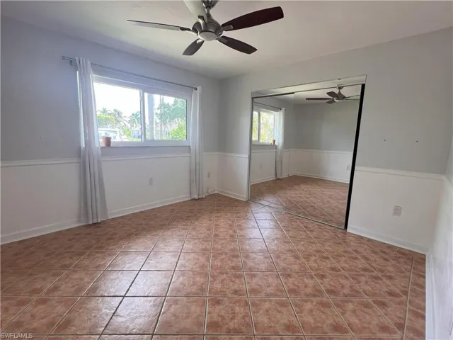 Tiled empty room featuring ceiling fan