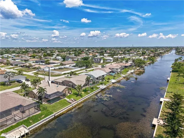 Aerial perspective of suburban area with a large body of water