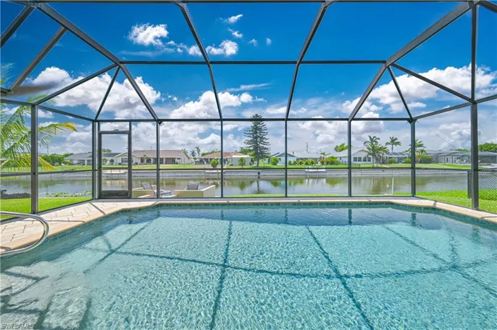 Outdoor pool featuring a water view, a lanai, and a residential view
