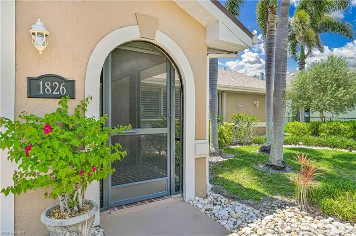View of exterior entry featuring stucco siding