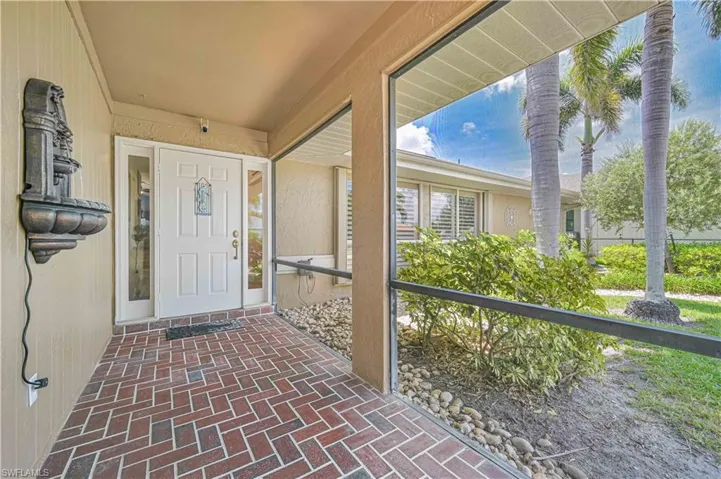Property entrance featuring stucco siding