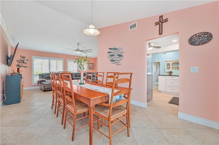 Dining room featuring ceiling fan, light tile patterned floors, and baseboards
