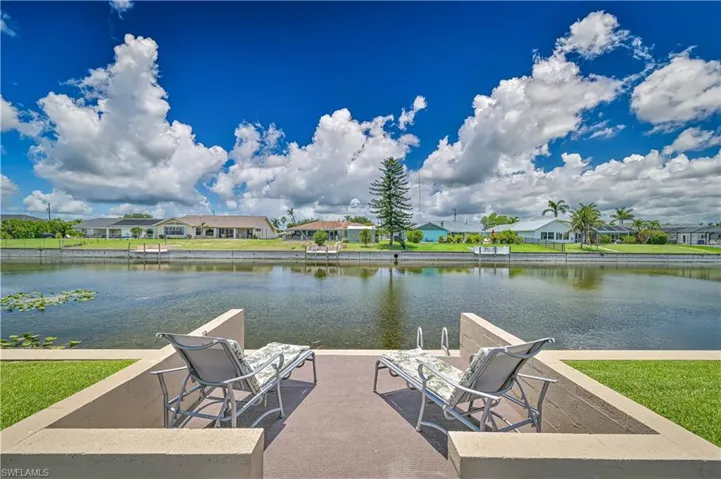 Dock with a water view and a residential view