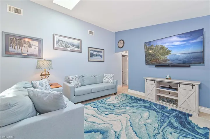 Living room with baseboards and a skylight
