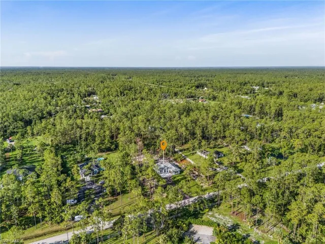 Aerial view of property's location featuring a heavily wooded area