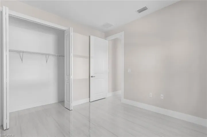 Unfurnished bedroom with baseboards and a closet