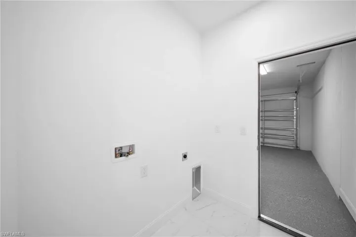 Clothes washing area with washer hookup, hookup for an electric dryer, and light tile floors